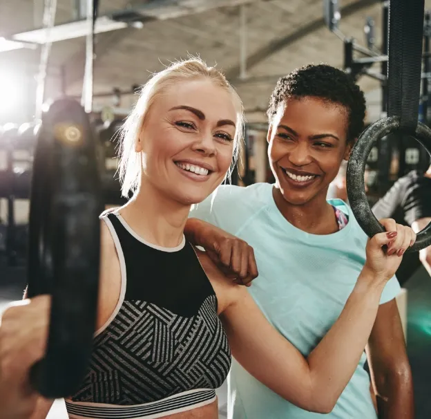 smiling women preparing to workout with rings at t utc
