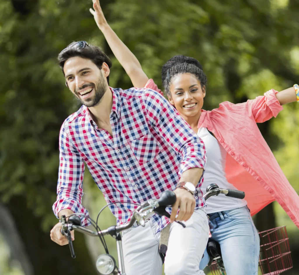 young couple riding on the tandem bicycle utc