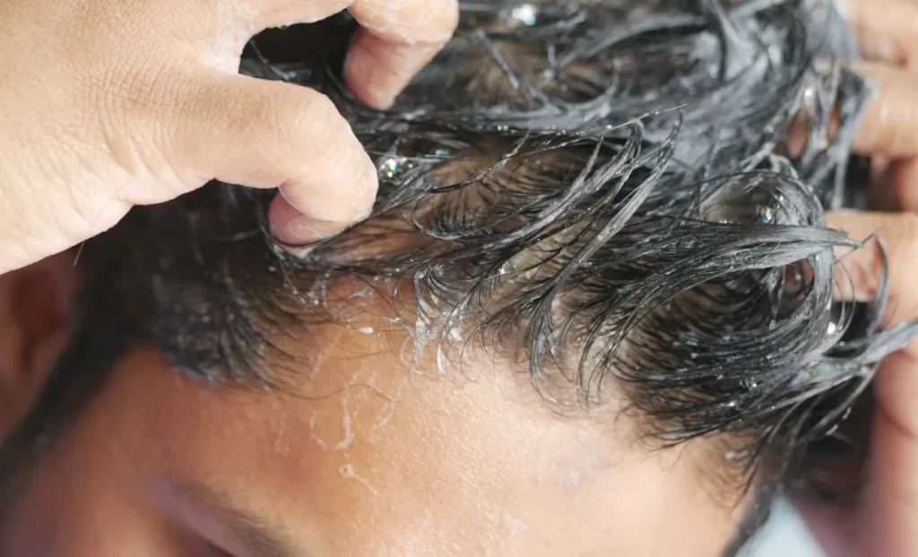 young men washes h his hair with shampoo utc